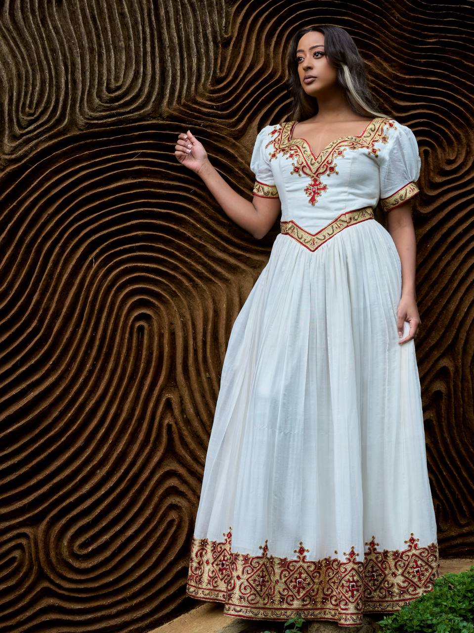 Garden Gold Gown — A romantic white gown with crimson and gold embroidery, photographed across an elegant garden series.