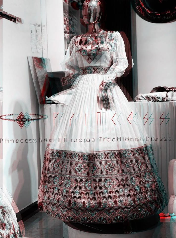 Pleated Tibeb Dress — Softly pleated skirt paired with a richly patterned yoke and belt.