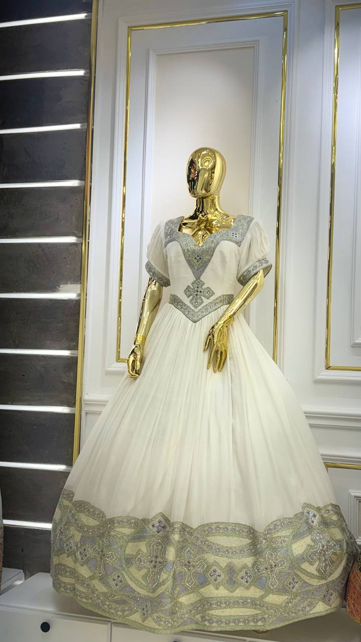 Ivory Silver Gown — Ivory gown with silver embroidery framing the bodice and a wide shimmering hem.