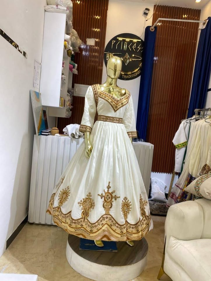 Ivory & Gold Zuria — Flowing ivory zuria with golden motif work across the skirt and cuffs.